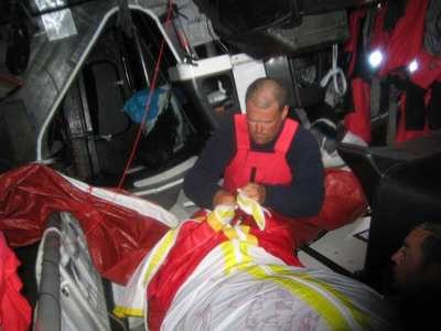 Packing the spinakker below decks on Volvo Open 70 The Black Pearl ©Justin Clougher © Volvo Ocean Race http://www.volvooceanrace.com