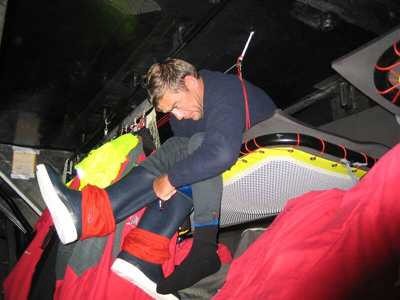 Crewmember gets dressed in a bunk in the cramped quarters on Volvo Open 70 The Black Pearl on below decks day7 Leg 2 ©Justin Clougher © Volvo Ocean Race http://www.volvooceanrace.com