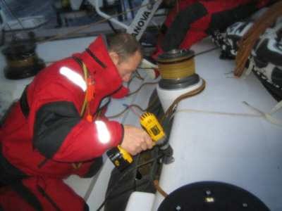 Crewmember repairing fixtures on deck on Volvo Open 70 The Black Pearl day7 Leg 2 ©Justin Clougher © Volvo Ocean Race http://www.volvooceanrace.com