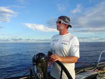 Onboard Ericsson Racing Team, Watch Leader Neal McDonald tries to keep the sun off his face as he helms in high temperatures. Volvo Ocean Race Leg 5 from Rio to Baltimore.  © Volvo Ocean Race http://www.volvooceanrace.com