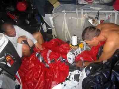 Dirk de Ridder and Justin Ferris repairing the spinnaker in the heat below deck onboard Pirates of the Caribbean. Volvo Ocean Race Leg 5 from Rio to Baltimore.  © Volvo Ocean Race http://www.volvooceanrace.com