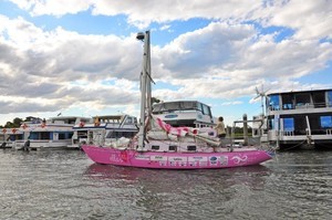 Battered, but unbowed, 'Ella's Pink Lady', Jessica standing in the cockpit, approaching the safe haven of the Gold Coast City Marina. - Jessica Watson photo copyright Gold Coast City Marina taken at  and featuring the  class