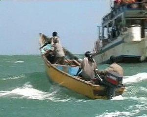Pirates on speedboat approach one of their mother boats docked near Eyl, Somalia in this framegrab made from a November 24, 2008 TV footage. The enclave of Eyl is the homeground of pirates who are wreaking havoc on the waters off the coast of Somalia. To date experts say that more than a dozen ships are still being held by pirates, with dozens others having paid massive ransom for their freedom.   REUTERS/Reuters TV (SOMALIA) photo copyright SW taken at  and featuring the  class