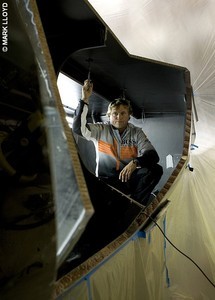 Alex Thomson on the damaged Hugo Boss during repair work photo copyright Mark Lloyd http://www.lloyd-images.com taken at  and featuring the  class
