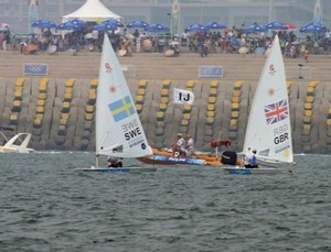 Paul Goodison (GBR) and Rasmus Myrgren (SWE) indulge in a match race - 2008 Olympics Qingdao - Medal Race - Laser photo copyright Richard Gladwell www.photosport.co.nz taken at  and featuring the  class