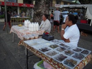 Locals selling all sorts of coconut dishes and coconut milk on Huahine photo copyright www.takingthekids.com taken at  and featuring the  class