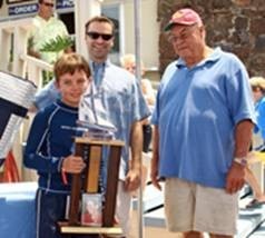 Patrick Dunn, first-place winner in the
largest class (Sabot C3s) is awarded the Jessica Uniack Memorial Beach to Bay Race trophy by Alex Uniack (behind)and Bill Uniack (r)    
 photo copyright Rick Roberts  taken at  and featuring the  class
