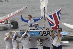 Paul Goodison (Gold medalist in the Laser class at the 2008 Olympic regatta) is carried from water by team mates including Team Manager Stephen Park and triple Gold medalist Ben Ainslie photo copyright Steve Arkley http://www.sailshots.co.uk taken at  and featuring the  class