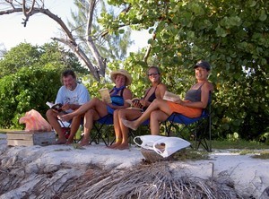 Swapping books while Greg barbecued our fish photo copyright SW taken at  and featuring the  class