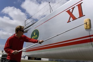 Wild Oats XI crewman Josh Whittaker washing down the dusty 98 foot maxi which has been in storage for seven months photo copyright Andrea Francolini/ Wild Oats www.afrancolini.com taken at  and featuring the  class
