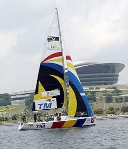 Smooth sailing: Sailors in a TM-sponsored keel boat sailing past the Putrajaya International Convention Centre building (in the background). photo copyright Rohaizat Md Darus taken at  and featuring the  class