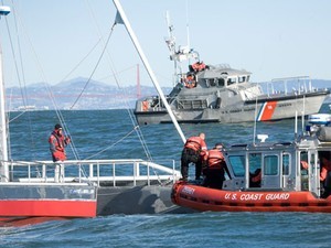 The U.S. Coast Guard pays a friendly visit to Vann, examining his boat before letting him sail on photo copyright Peter Lyons . http://www.lyonsimaging.com/ taken at  and featuring the  class