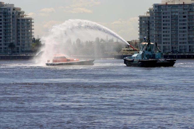 Water streaming off her decks as Akuna IV gets taken to the salt water wash. ©  John Curnow