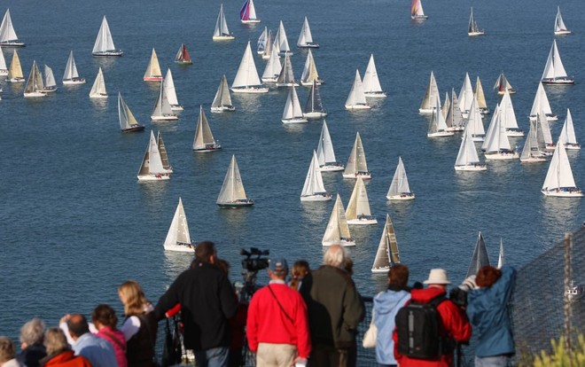 Crowds on top of the Needles watch the fleet of 1,754 boats round the Needles on the Isle of Wight during the J.P. Morgan Asset Management Round the Island Race. © onEdition http://www.onEdition.com