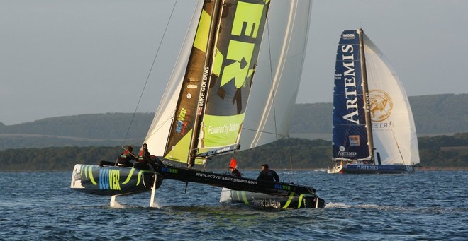 Extreme 40 Ecover, helmed by Mike golding and rival team Artemis Ocean Racing, helmed by Graham Tourell during the J.P. Morgan Asset Management Round the Island Race as the sun rises over the Solent at 5am this morning. © onEdition http://www.onEdition.com