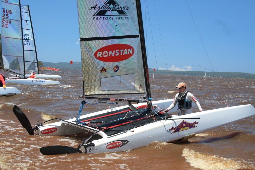 Glen Ashby lauches his boat with a focussed mind on winning - A-Class Cats Nationals Sailing Regatta © Mia Hacker http://www.miahacker.com