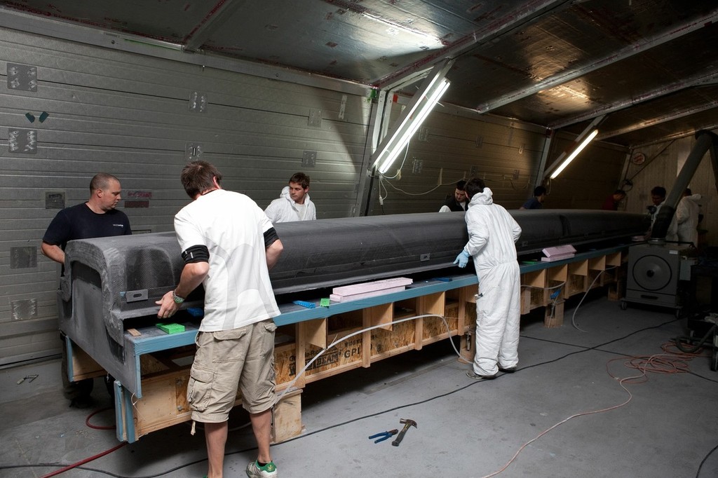 Lifting off the female mould from the male plug - the deck side of the mould is nearest the camera. The builders are working inside one of the temperature controlled 