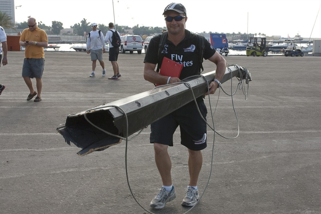 Emirates Team New Zealand shore crew manager Andy Mottage carries a piece of the splintered spinnaker pole after the collision with Mascalzone Latino (ITA) in race two. Day one of the Louis Vuitton Dubai regatta. 13/11/2010 &copy; Chris Cameron/ETNZ http://www.chriscameron.co.nz