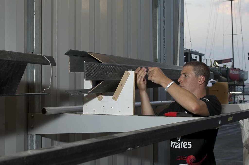 Emirates Team New Zealand boatbuilders go to work on the damage to the hull of NZL84. Louis Vuitton Dubai Trophy regatta. 14/11/2010 &copy; Chris Cameron/ETNZ http://www.chriscameron.co.nz
