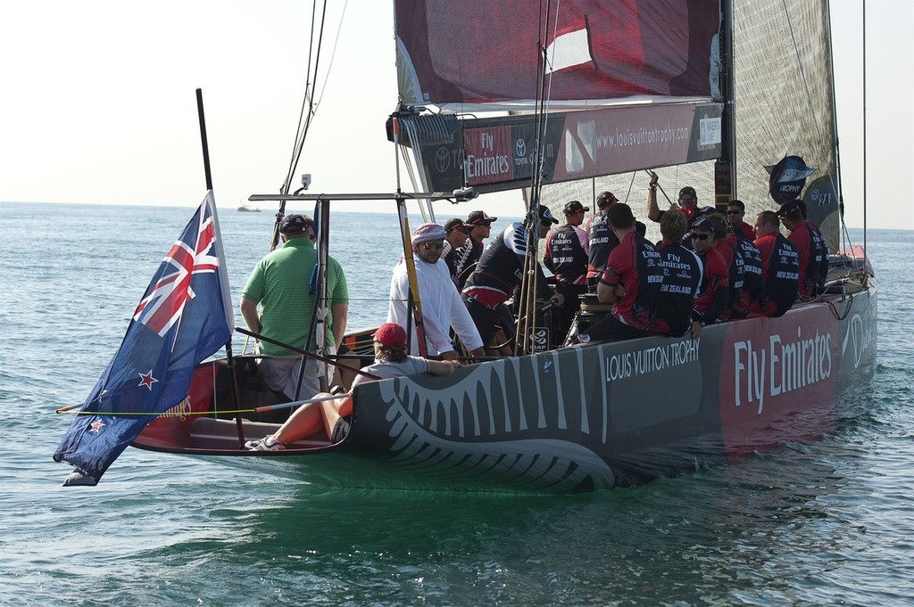 Emirates Team New Zealand sailors wear black arm bands and fly the New Zealand flag at half mast for the miners killed in the Pike River coal mine tragedy. Fleet racing day. . Louis Vuiton Trophy Dubai. 25/11/2010 © Chris Cameron/ETNZ http://www.chriscameron.co.nz