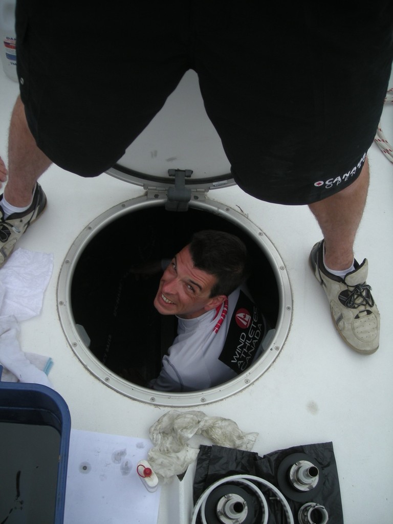 Nathan Baron peeks through the forward hatch on O Canada photo copyright Wind Athletes Canada - Ingrid Johansson taken at  and featuring the  class