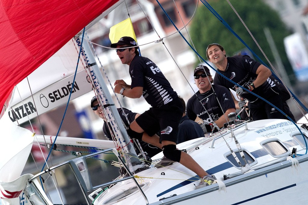 Black Match crew members during a spinnaker hoist on day 3 of Match Race Germany 2010. World Match Racing Tour. Langenargen, Germany. 22 May 2010. Photo: Gareth Cooke/Subzero Images/WMRT © WMRT http://www.worldmatchracingtour.com