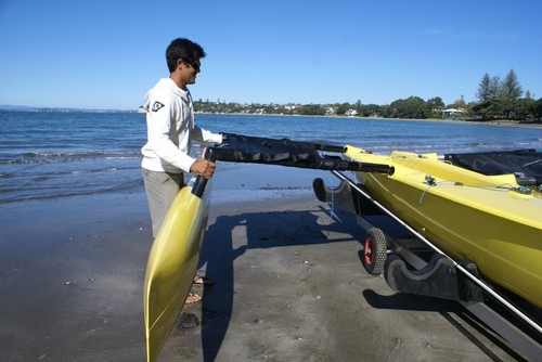 Chris Kitchen fits the slim wave piercing ama into its socket on the main hull - Weta Boat test - May 2010 © SW