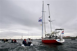 Laura Dekker steers her boat, with her father, Dick Dekker, at left, as they depart the harbor of Den Osse, south west Netherlands, Wednesday, Aug. 4, 2010. 14-year-old Laura Dekker, who hopes to become the youngest person to sail around the world by herself, and her father Dick Dekker have departed the harbor of Den Osse in her 38-foot (11.5-meter) yacht Guppy, bound for Portugal where she hopes to begin her solo attempt later this year. (AP Photo/Bas Czerwinski) photo copyright SW taken at  and featuring the  class