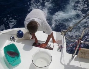 Seychelles - scaling fish on the back deck.JPG photo copyright Rolf and Irene Fricke taken at  and featuring the  class