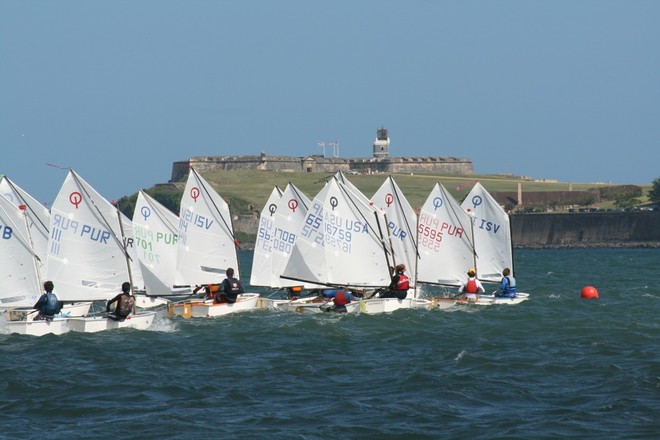 Opti's racing on San Juan Bay with historic El Morro in the background/Credit: Raquel Torres Arzola - Club Nautico de San Juan International Regatta © Raquel Torres Arzola