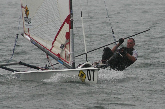 Britain’s Tom Conway goes back ashore in the rain squall. - Musto Performance Skiffs Worlds ©  John Curnow