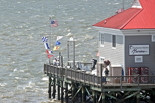 Flags snapped to attention in stiff gusts on the end of the Charleston Harbor Marina  - Charleston Race Week 2011 © Meredith Block/ Charleston Race Week http://www.charlestonraceweek.com/