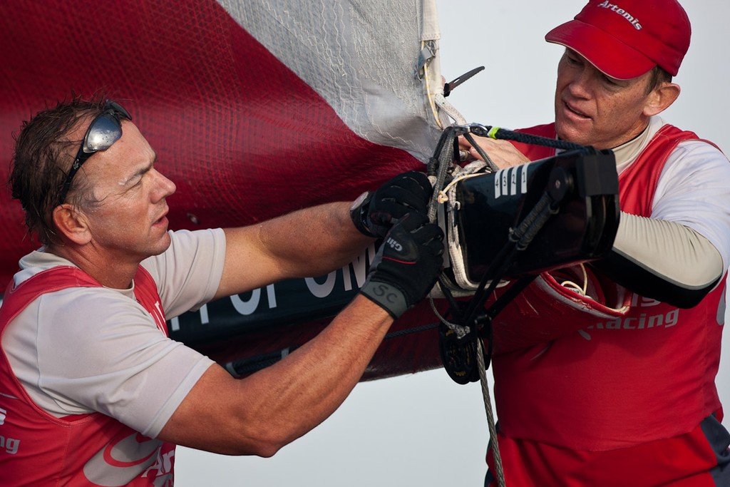 Morgan Trubovich and Sean Clarkson are undowing out the reef. Second day of Racing, 21st of February. Extreme Sailing Series, Act 1, Muscat, Oman (20 - 24 February 2011)  © Sander van der Borch / Artemis Racing http://www.sandervanderborch.com
