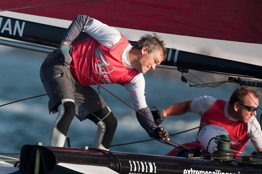 Andy Fethers furling the gennaker. 23rd of February, Day 4 of the Extreme Sailing Series, Act 1, Muscat, Oman (20 - 24 February 2011)  © Sander van der Borch / Artemis Racing http://www.sandervanderborch.com