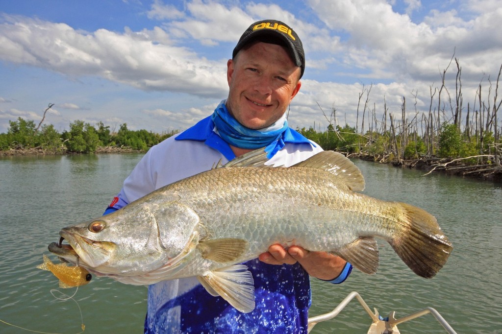 Jarrod with a solid Barr that took a liking to a soft plastic cast directly behind him in the mouth of the creek. © Jarrod Day