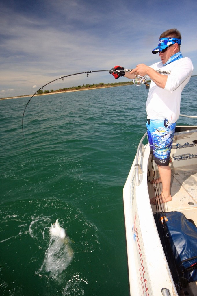 Jarrod tangles with a trevally boatside. © Jarrod Day