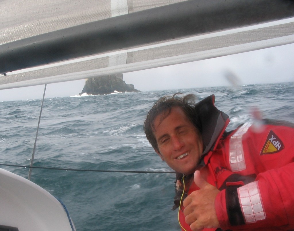 scott gives the thumps up on rounding Fastnet Rock - Uk mini fastnet Race © James Gair