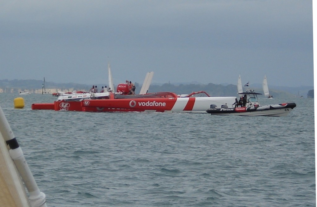 Dismasted Team Vodafone Sailing with ETNZ tenders assisting - Team Vodafone Sailing © Colin Preston