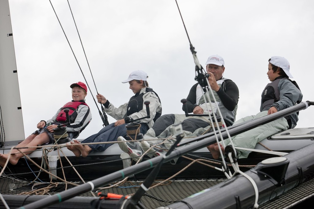 New Zealand national Optimist Champion, Leonard Takahashi-Fry on the handlebars of the AC45 © Gilles Martin-Raget / Oracle Racing