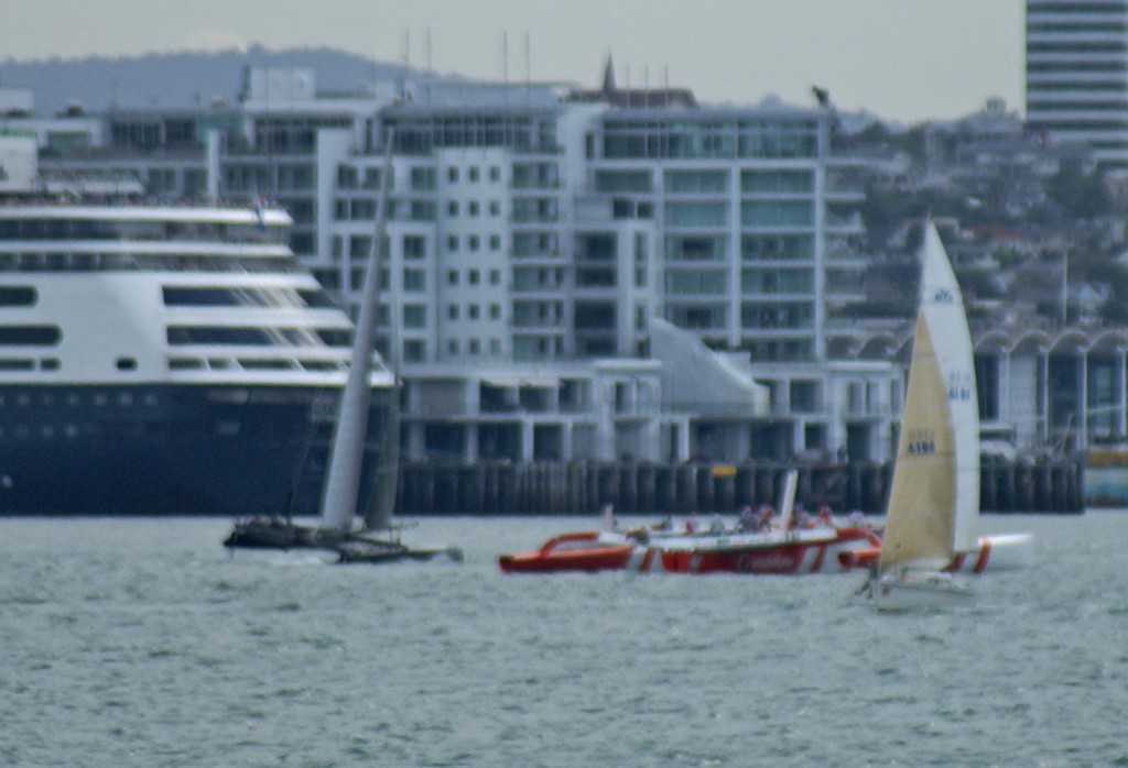 The dismasted TVS is passed by the AC45 on her return leg, not far from the place of the incident &copy; SW