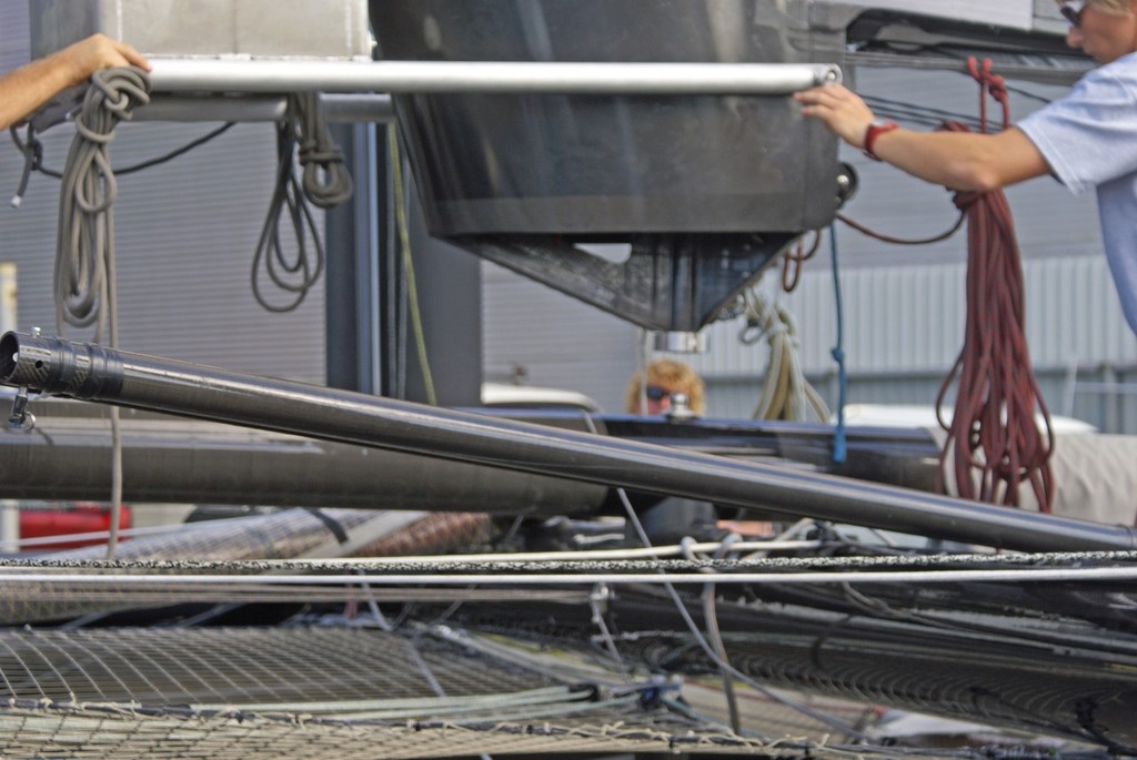 The wingsail is positioned by a crane operator with a remote control, standing almost alongside the hull and with a very precise view of the wingsail/platform closure. Note watertank in position to top left of picture  - AC45 Rigging - 14 February 2011 photo copyright Richard Gladwell www.photosport.co.nz taken at  and featuring the  class