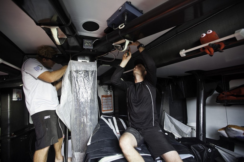 Casey Smith and Tom Addis begin disconnecting fittings around the mast boot. Puma Ocean Racing  © Amory Ross/Puma Ocean Racing/Volvo Ocean Race http://www.puma.com/sailing