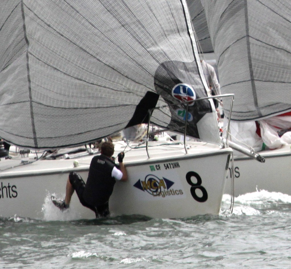 Tactician Nils Bjerkas slipped overboard as Staffan Lindberg spun the boat around the end of the finish line to beat Evgeny Neugodnikov - Congressional Cup - Long Beach YC - Day 2 © Rich Roberts http://www.UnderTheSunPhotos.com