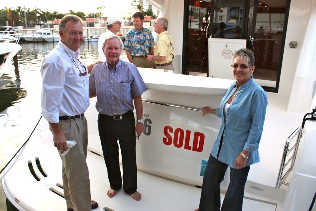 Maritimo USA’s John McCarthy (left) with two happy new owners.  © Bob Wonders
