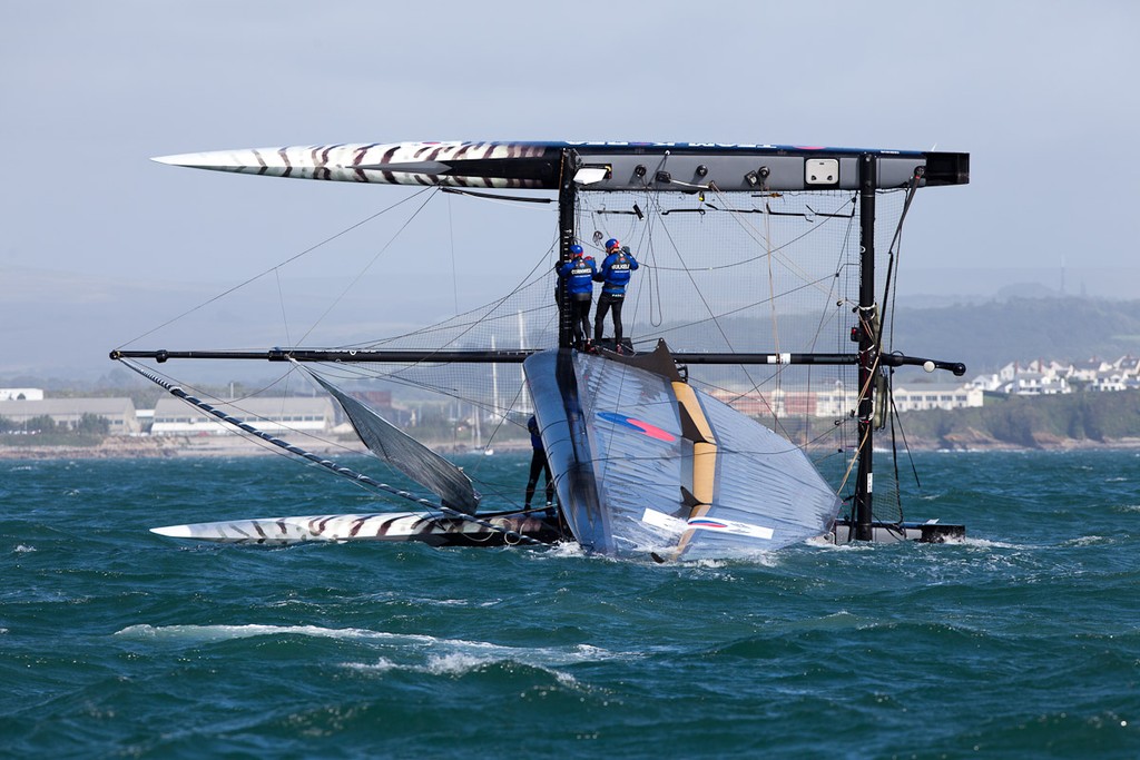 Team Korea capsizing at the top mark - America’s Cup World Series Plymouth 2011 © Sander van der Borch http://www.sandervanderborch.com