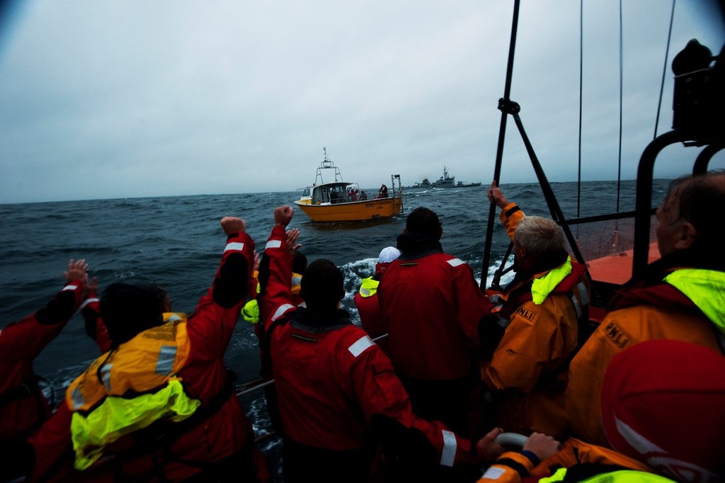 Rambler crew leave the capsized yacht - Photos from the Fastnet Race rescue taken by Nigel Millard © SW