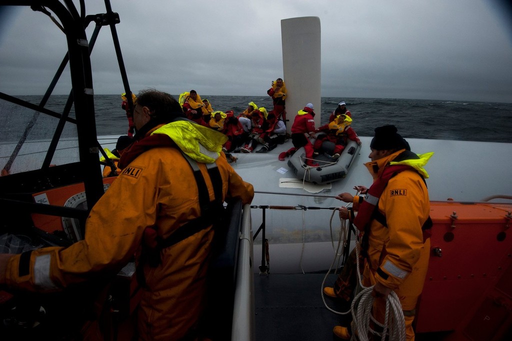 Rambler crew with the bulb-less keel of the upturned yacht clearly visible - photos from the Fastnet Race rescue taken by Nigel Millard photo copyright SW taken at  and featuring the  class