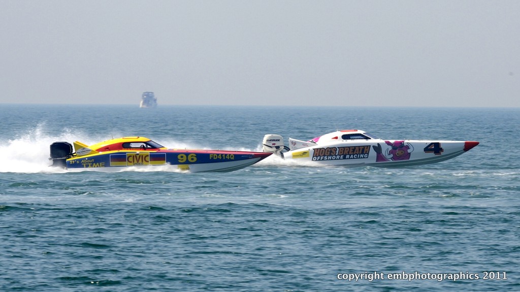'Hog's Breath' and 'It's About Time' battling for the minor places in Supercat Outboard Lite. - Redcliffe Offshore Race photo copyright Reg Blunt http://www.embphotographics.com.au taken at  and featuring the  class