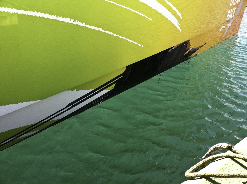 Team Sanya in the Mediterranean port of Motril assessing the state of their boat after hull damage forced them to suspend racing on Leg 1 of the Volvo Ocean Race 2011-12.  © Team Sanya