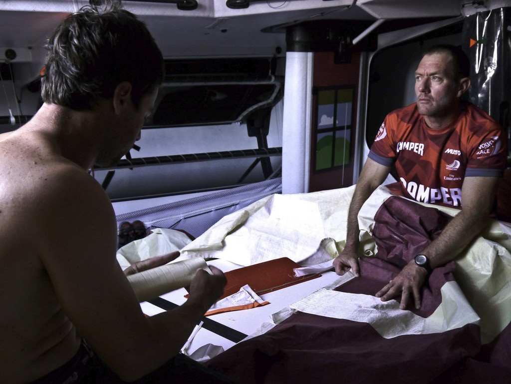 Tony Rae and Daryl Wislang repair a torn sail onboard CAMPER with Emirates Team New Zealand during leg 1 of the Volvo Ocean Race 2011-12 © Hamish Hooper/Camper ETNZ/Volvo Ocean Race